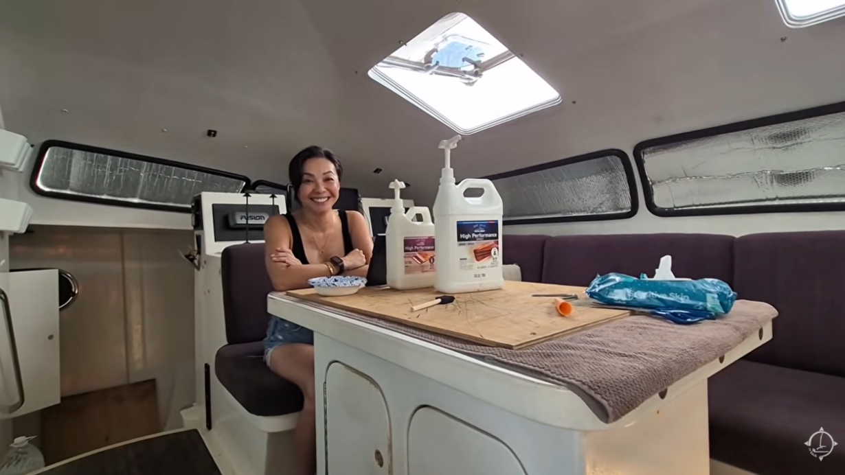woman sitting in boat with epoxy bottles infront