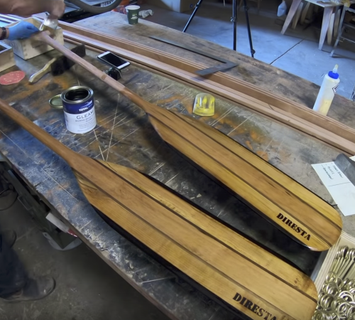 Jimmy Diresta applying TotalBoat Gleam Marine Spar Varnish to handcrafted canoe paddles