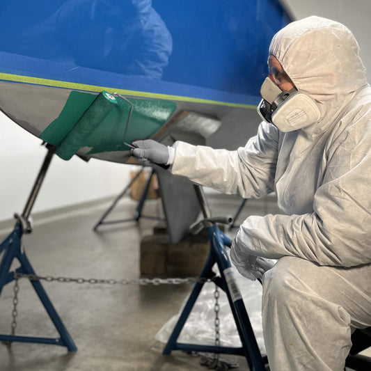 TotalBoat Antifouling Bottom Paint Supplies Kit: Rolling green paint on a boat bottom