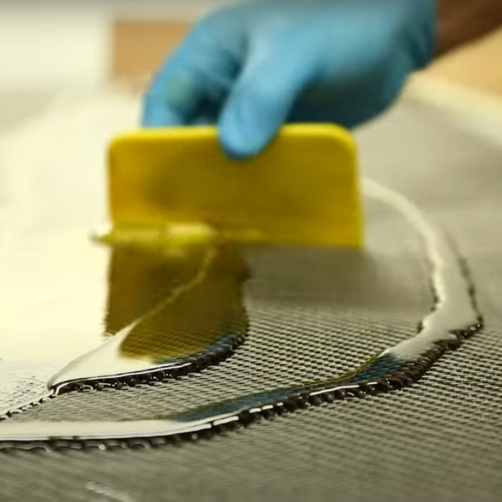 TotalBoat Traditional 5:1 Epoxy Resin Kit Resin being spread onto fiberglass cloth