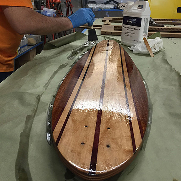 TotalBoat Penetrating Epoxy Sealer being applied to a board