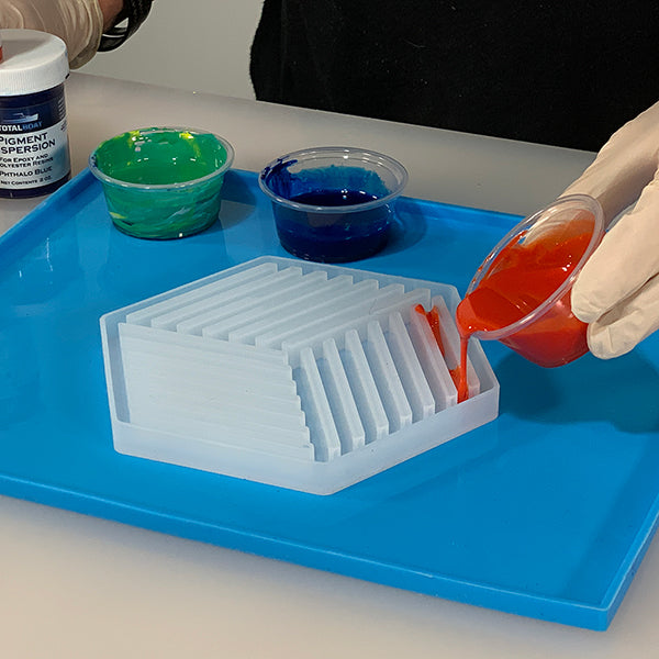 TotalBoat Pigment Dispersion Red, mixed into epoxy, being poured into a mold