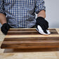 TotalBoat Wood Honey Food Safe Wood Finish being wiped on a serving board