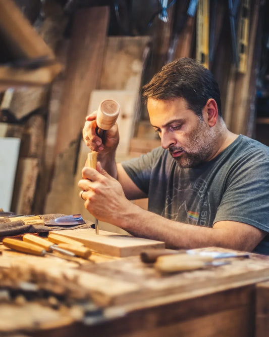 Paul from Copper Pig using hand tools in his workshop