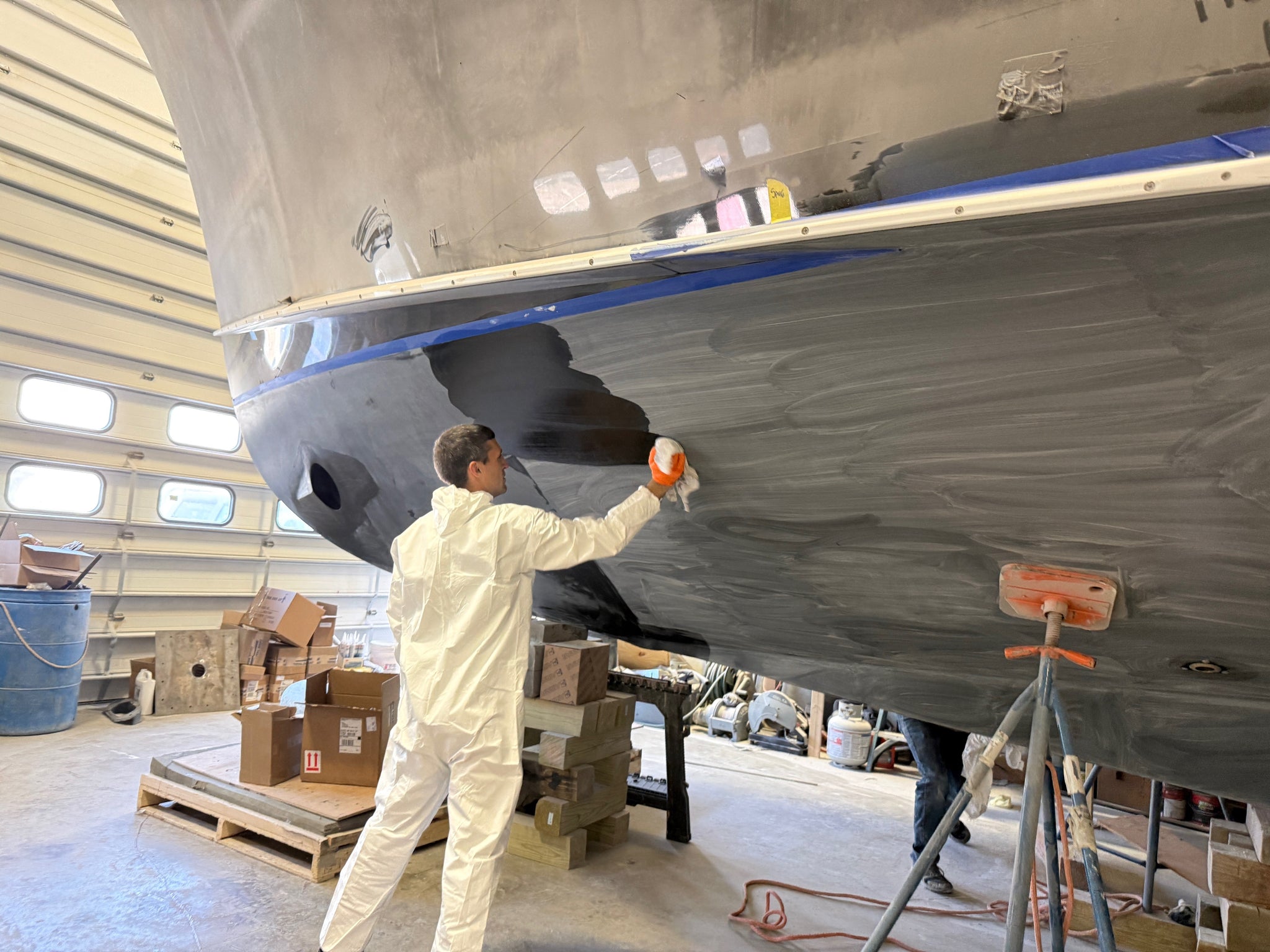 man painting the bottom of a boat