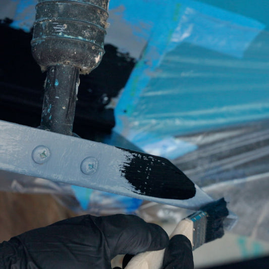 TotalBoat Outdrive AF Prop and Outdrive Antifouling paint being brushed on boat metals