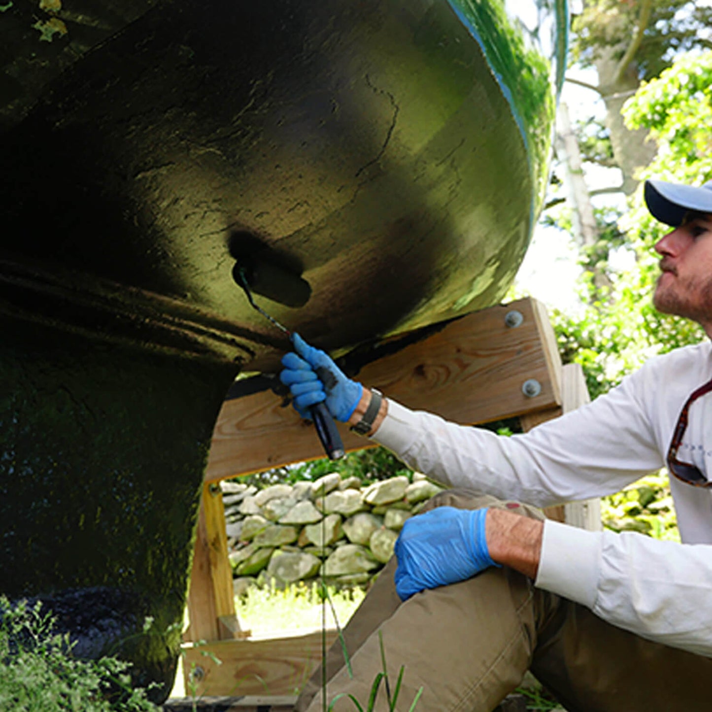 JD Select Water-Based Bottom Paint black being rolled on a boat