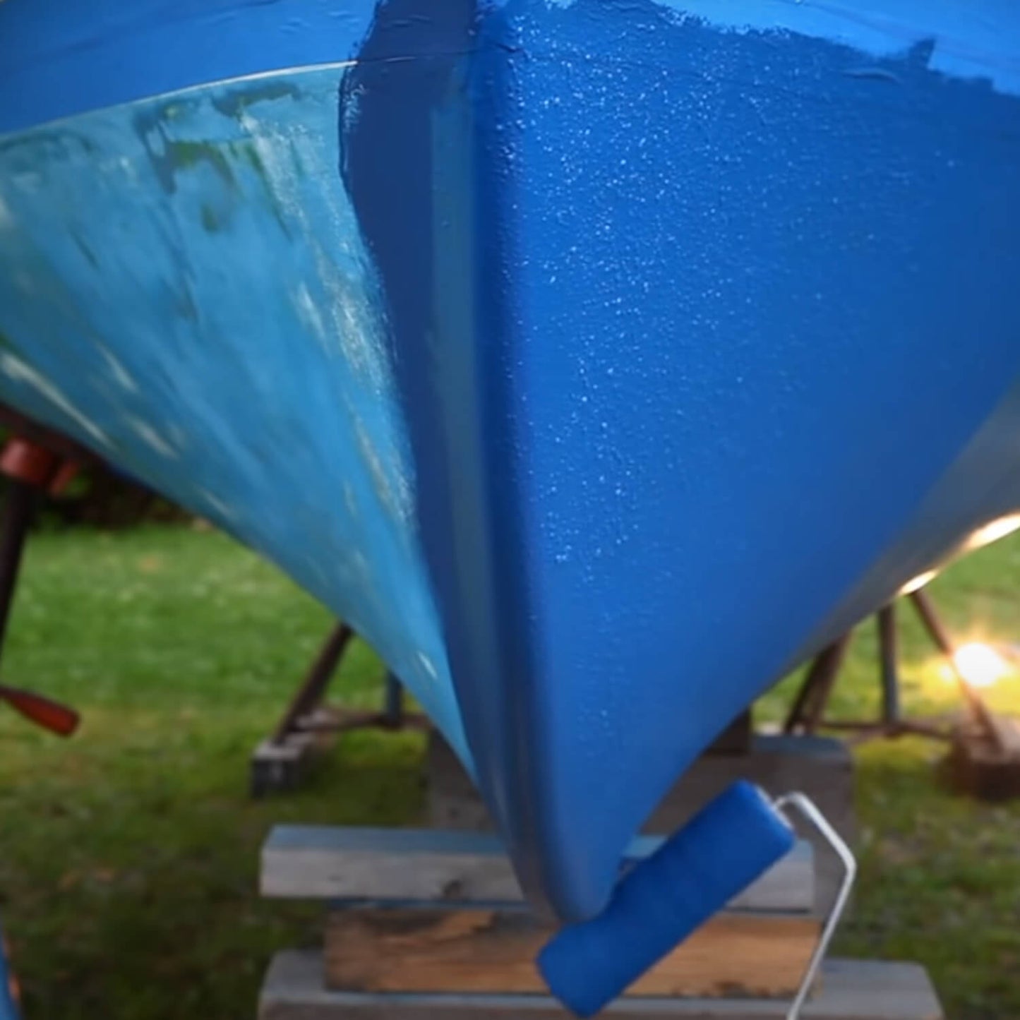 JD Select Water-Based Bottom Paint blue being rolled on a boat