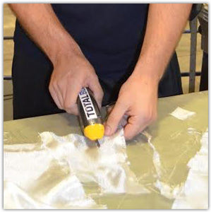 Person cutting fiberglass with electric scissors