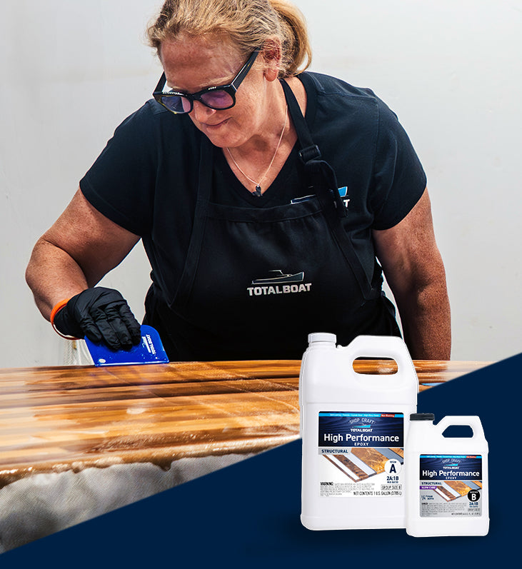 Kristin Brown from TotalBoat spreading High Performance Epoxy on paddle board with packaging showing