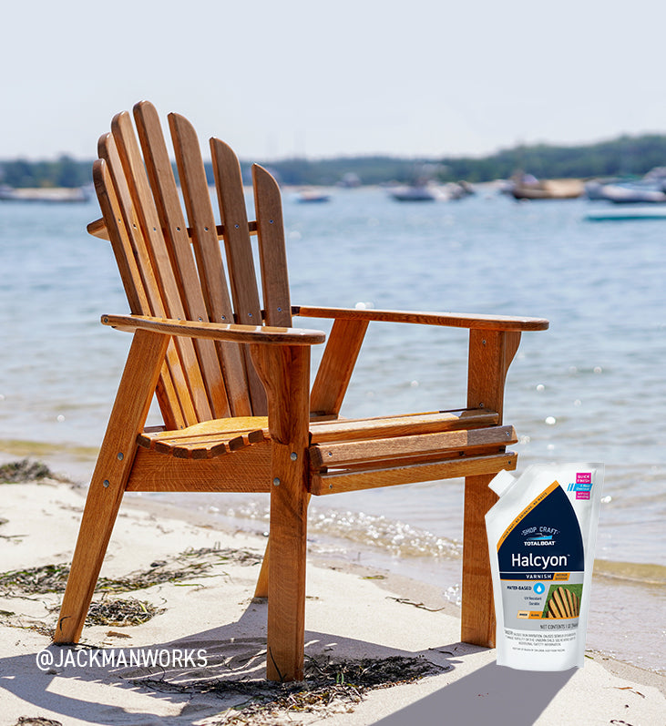 TotalBoat Halcyon Marine Varnish Shown with Wooden Adirondack Chair on Coastal Beach