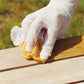 TotalBoat Teak Oil being applied to wood with a rag