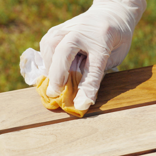 TotalBoat Teak Oil being applied to wood with a rag