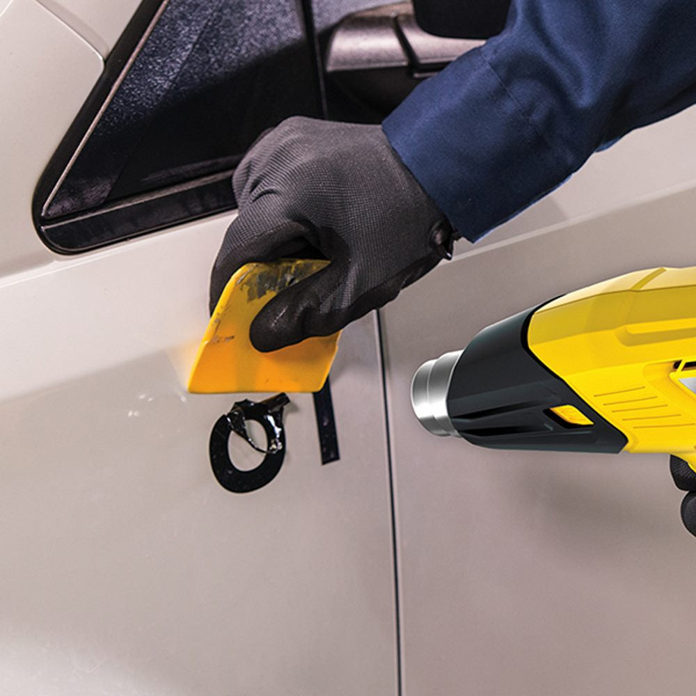 Heat Gun being used to remove decal from car