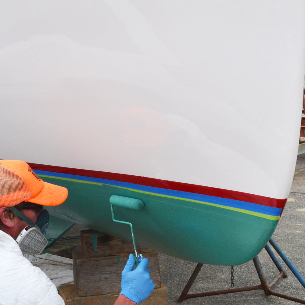 TotalBoat Krypton Green being applied to a boat with a roller