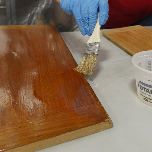 TotalBoat Penetrating Epoxy Sealer being applied to a board