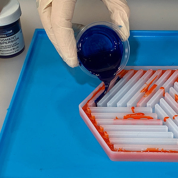 TotalBoat Pigment Dispersion Blue, mixed into epoxy, being poured into a mold