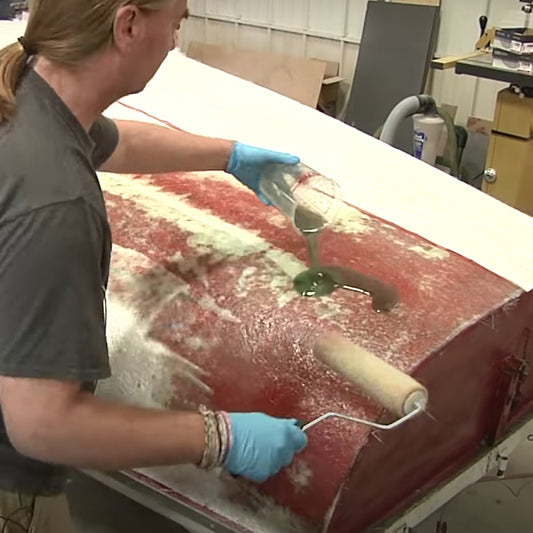 TotalBoat Polyester Laminating Resin being poured on a boat for rolling