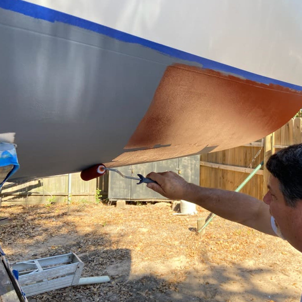 TotalBoat Spartan Multi-Season Antifouling Paint Red being applied with a roller