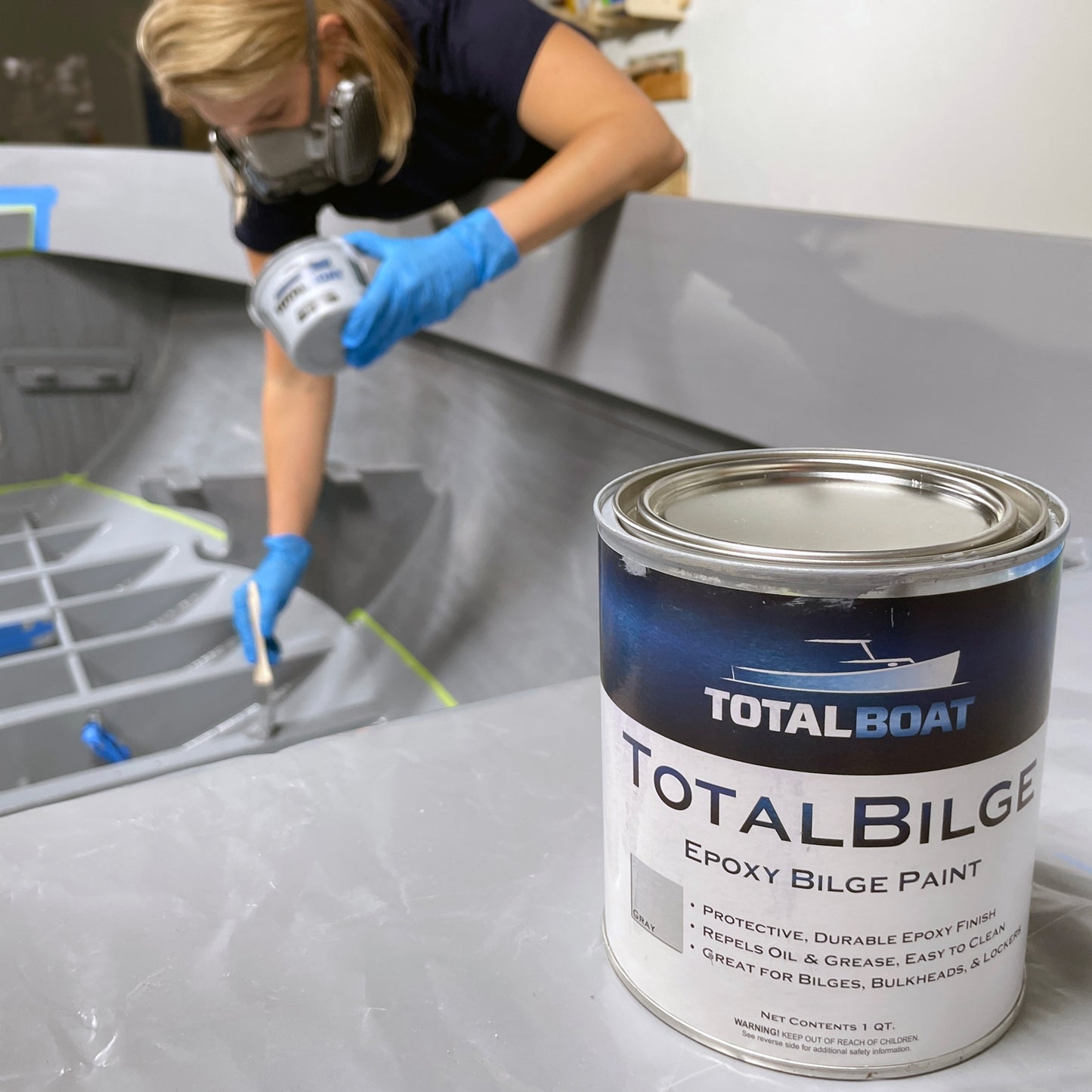 TotalBoat TotalBilge Epoxy Bilge Paint being applied to the inside of a boat