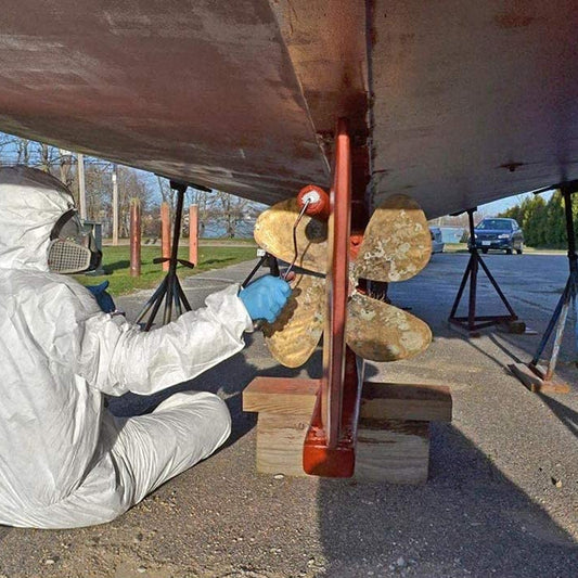 TotalBoat Underdog Boat Bottom Paint red being rolled on a boat